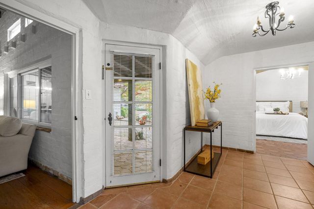 a bathroom with a granite countertop sink mirror vanity and toilet