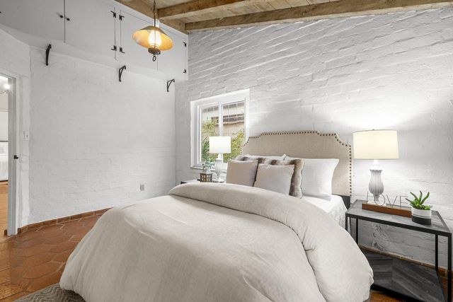 a view of a chair and table in backyard of the house