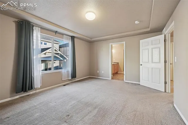 an empty room with closet and windows