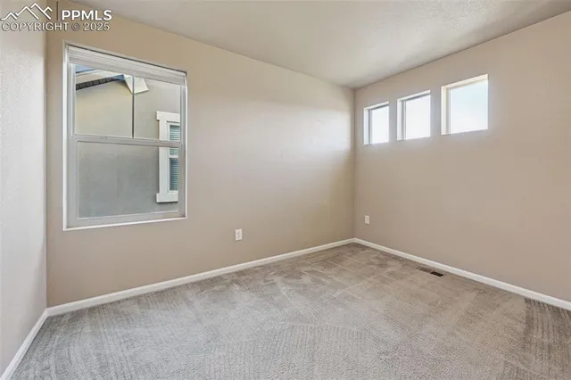 an empty room with closet and a bathroom
