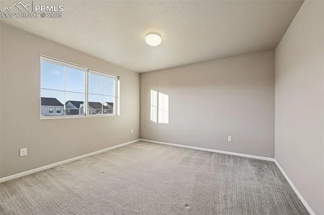 an empty room with windows and closet