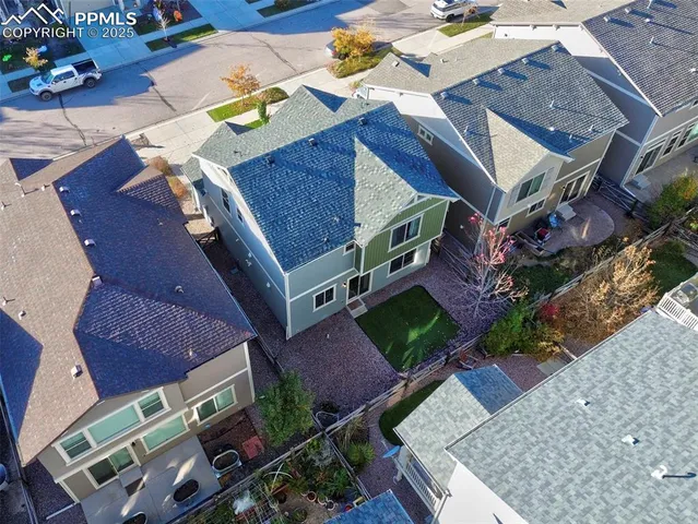 an aerial view of multiple houses with a yard