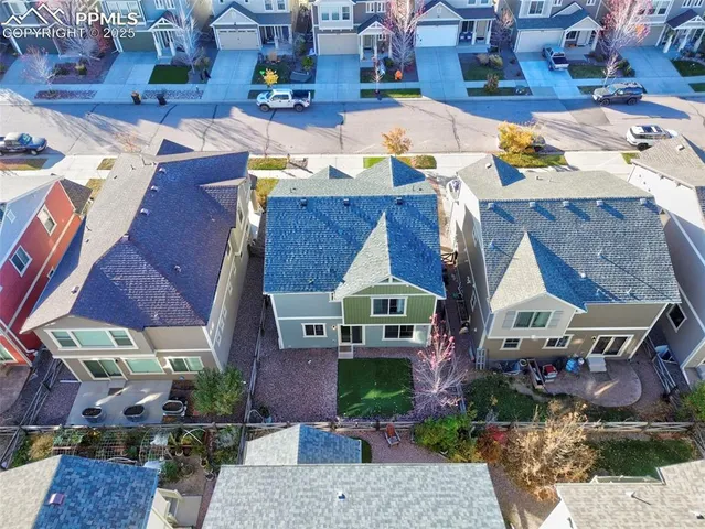 an aerial view of a house with a yard