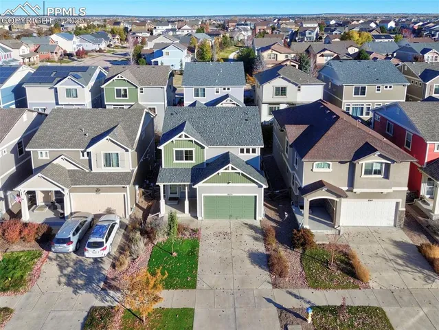 an aerial view of residential houses with outdoor space