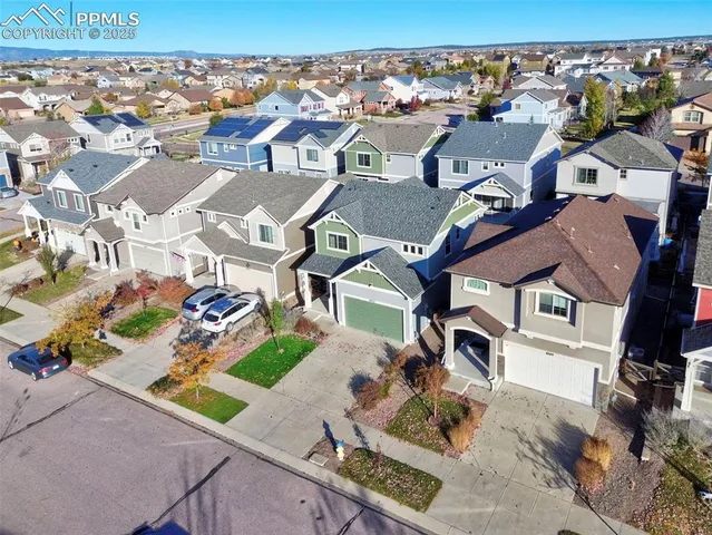a front view of a house with a yard and potted plants