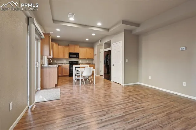 a view of a kitchen with cabinets and wooden floor