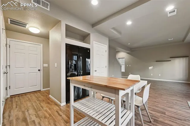 a view of a dining area with furniture and wooden floor