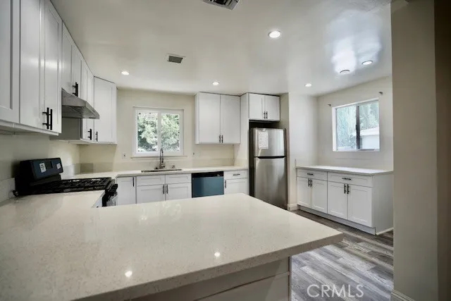 a kitchen with refrigerator and window