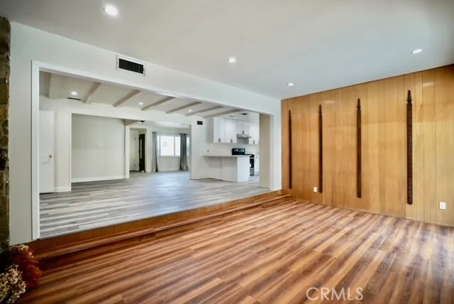 a view of a room with wooden floor and furniture