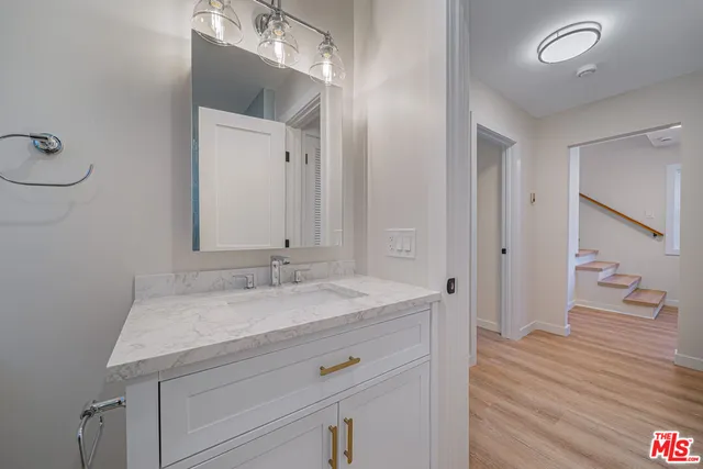a view of a hallway with wooden floor and closet