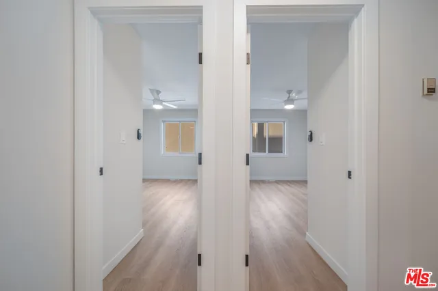 a view of a kitchen with a sink and a refrigerator