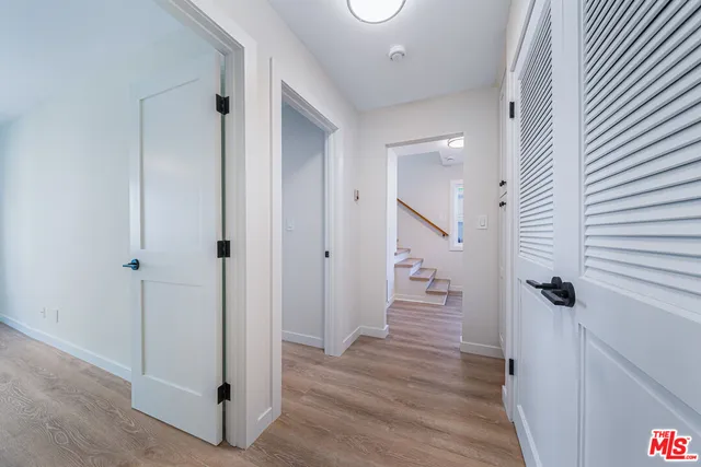 a kitchen with white cabinets and appliances