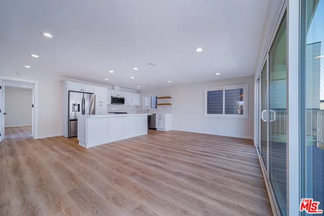 a kitchen with stainless steel appliances white cabinets and a granite counter tops