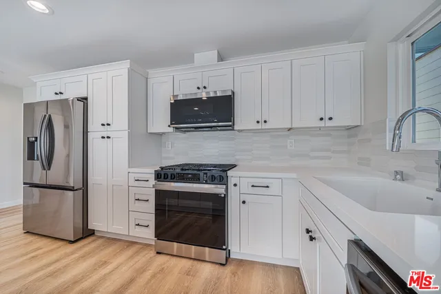 a view of kitchen with center island and wooden floor