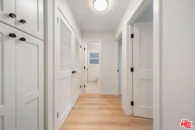 a bathroom with a granite countertop sink toilet and mirror