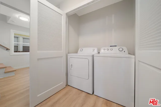 a bathroom with a granite countertop toilet sink and mirror