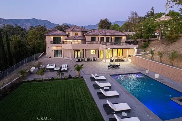 an aerial view of house with yard swimming pool and a yard