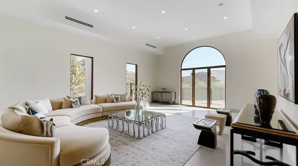 a living room with furniture and a large window