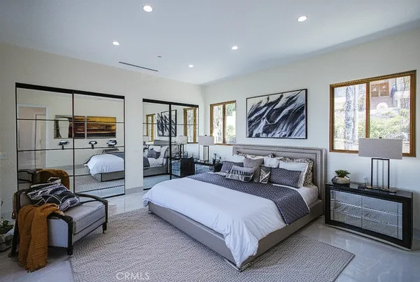 a bedroom with bed couch and window
