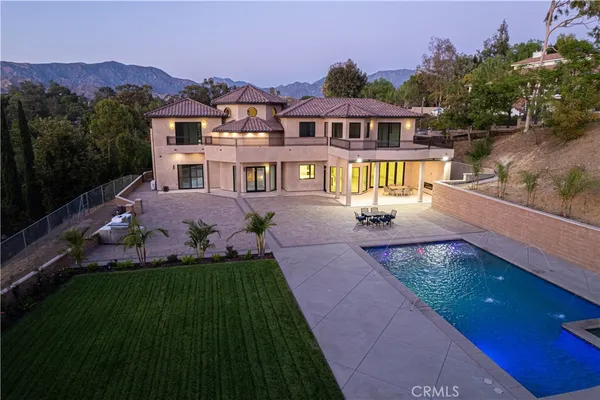 a front view of a house with a garden and yard