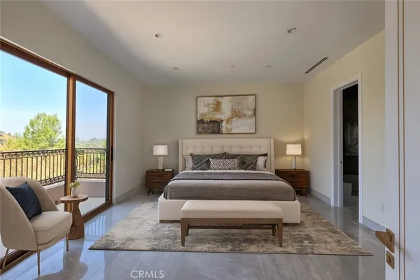 a bedroom with a bed and glass window