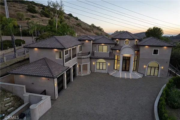 a aerial view of a house with sitting area and furniture