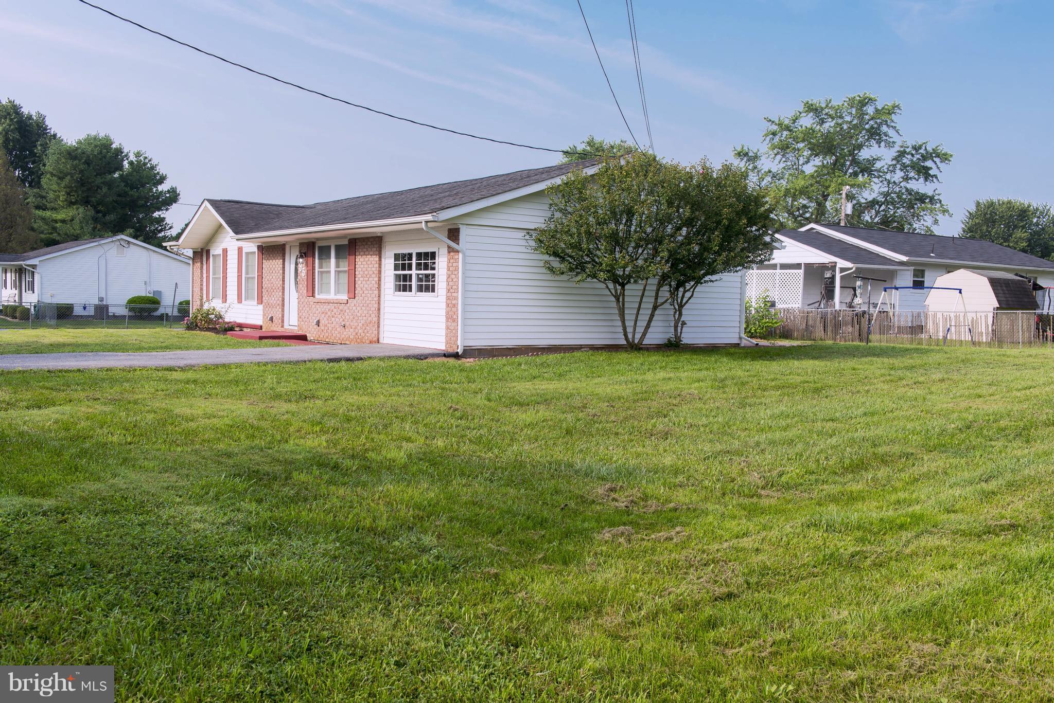 95 Orchard Drive Ranson, WV 25438 - Photo 2 of 22 a front view of a house with a garden