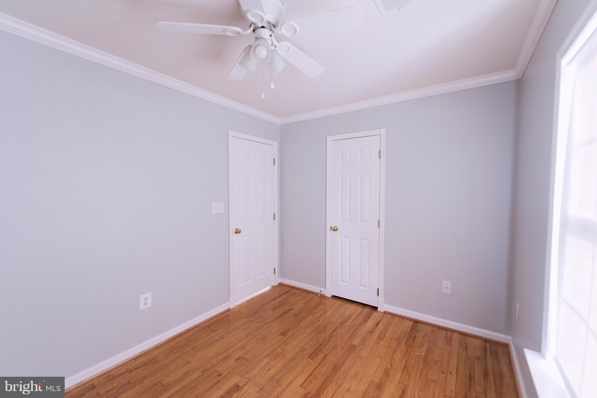 95 Orchard Drive Ranson, WV 25438 - Photo 16 of 22 a view of an empty room with wooden floor and a window