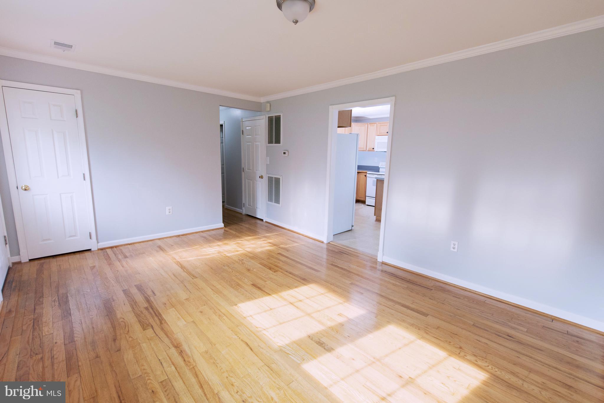 95 Orchard Drive Ranson, WV 25438 - Photo 4 of 22 a view of an empty room with wooden floor and a window