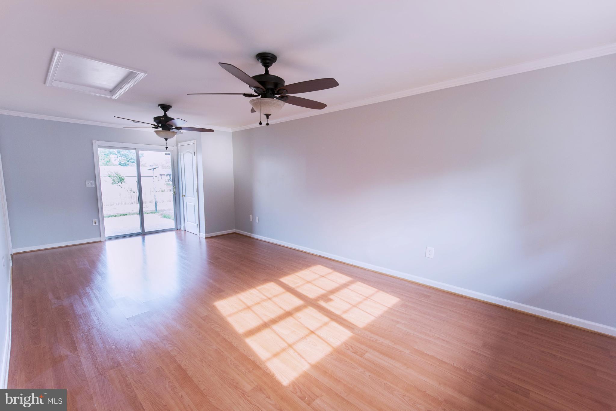95 Orchard Drive Ranson, WV 25438 - Photo 6 of 22 a view of an empty room with a window and wooden floor