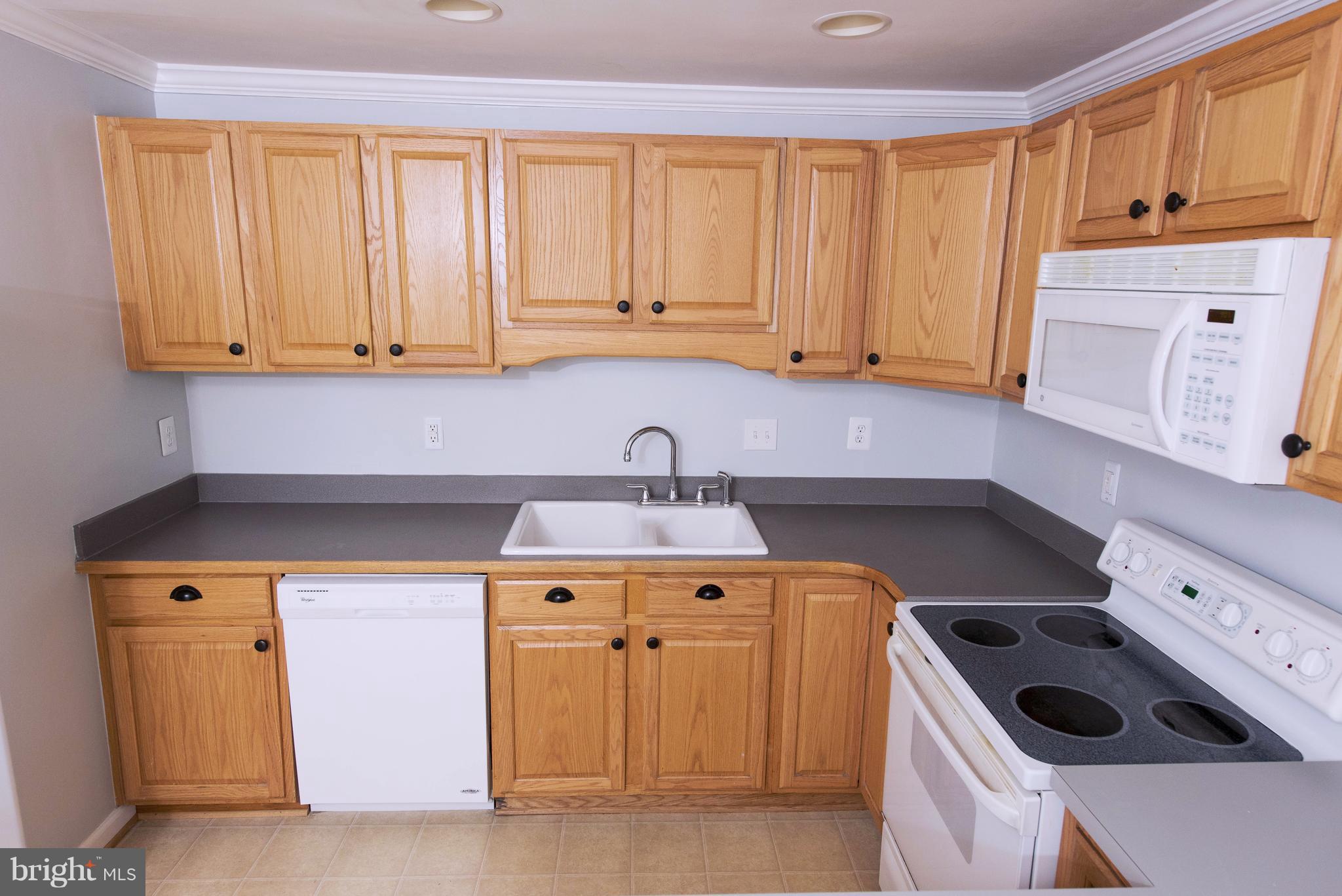 95 Orchard Drive Ranson, WV 25438 - Photo 8 of 22 a kitchen with a sink a stove and cabinets