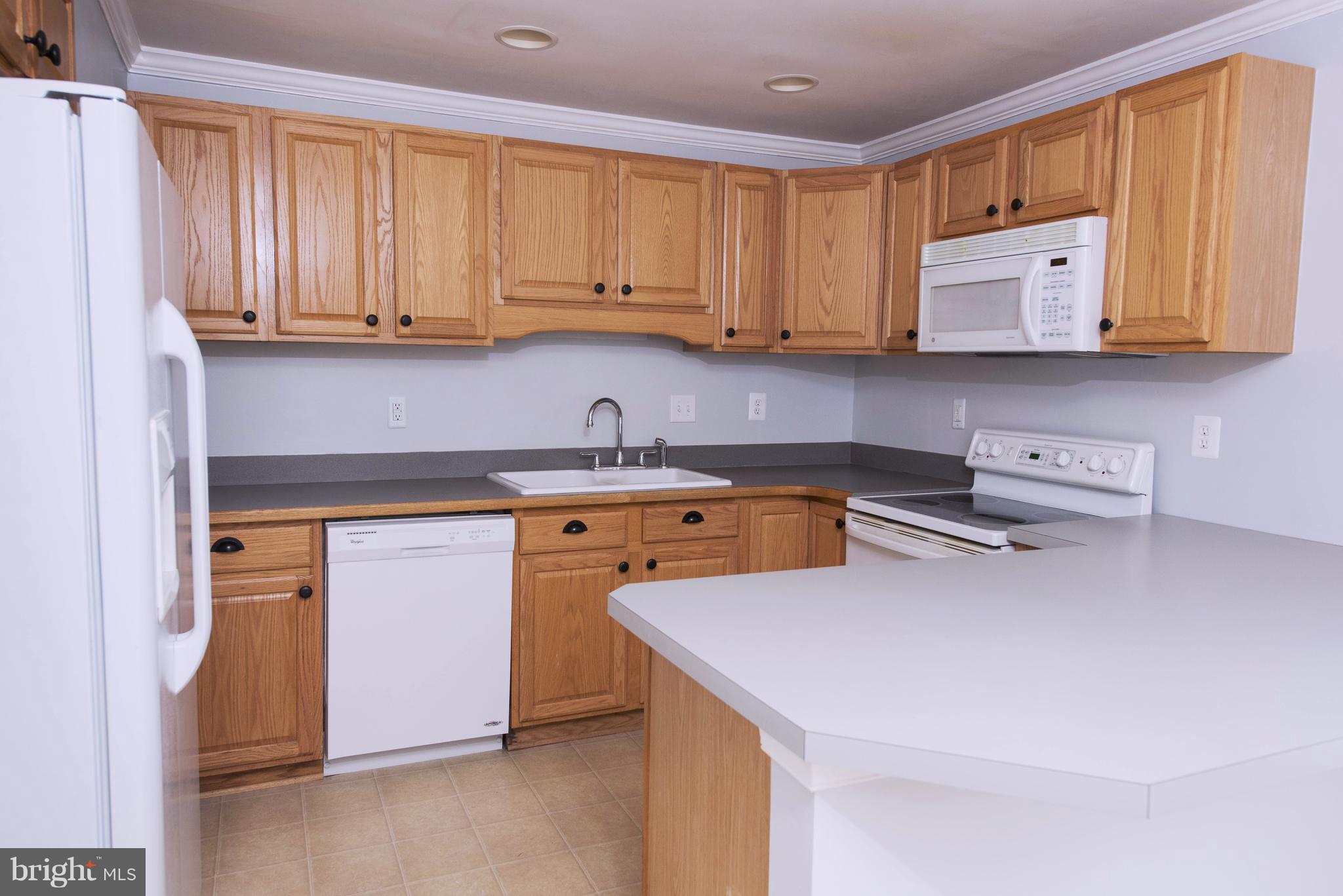 95 Orchard Drive Ranson, WV 25438 - Photo 10 of 22 a kitchen with a sink a stove and cabinets