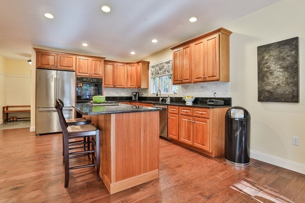 6 Whitney Road Boxford, MA 01921 - Photo 8 of 42 a kitchen with stainless steel appliances granite countertop a refrigerator sink and cabinets