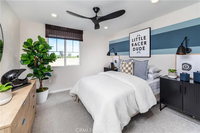 a bedroom with bed and a potted plant
