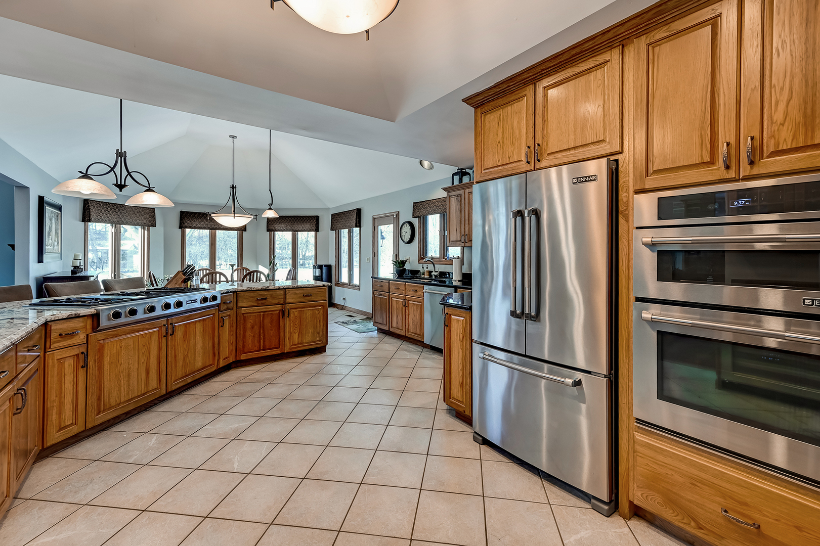 8300 South County Line Road Burr Ridge, IL 60527 - Photo 11 of 37 a kitchen with stainless steel appliances granite countertop a refrigerator a stove and a sink
