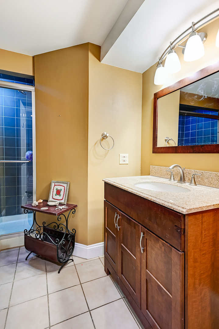8300 South County Line Road Burr Ridge, IL 60527 - Photo 26 of 37 a bathroom with a granite countertop sink and a mirror