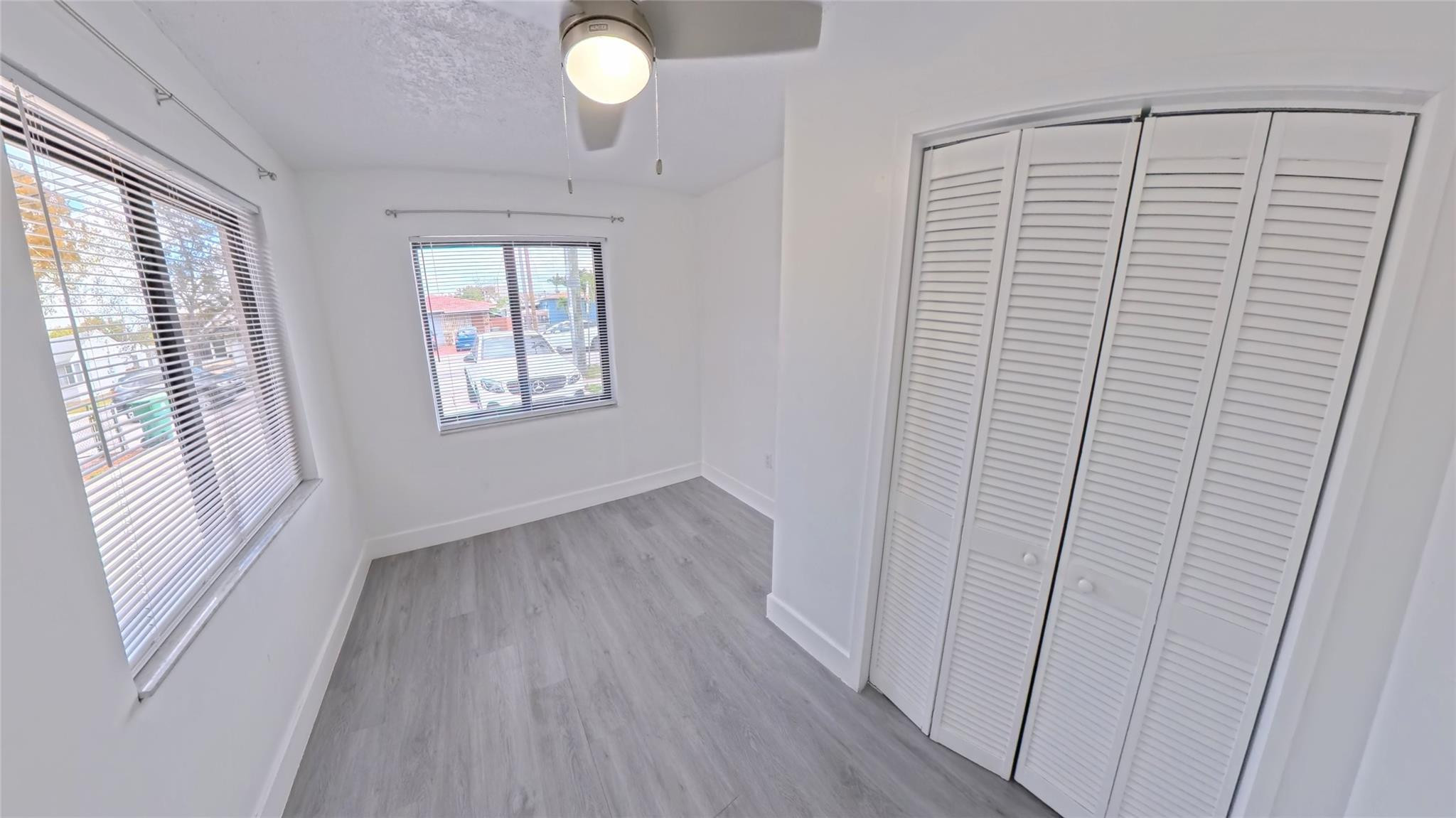 2620 Southwest 32nd Avenue Miami, FL 33133 - Photo 12 of 19 a view of an empty room with wooden floor and a window
