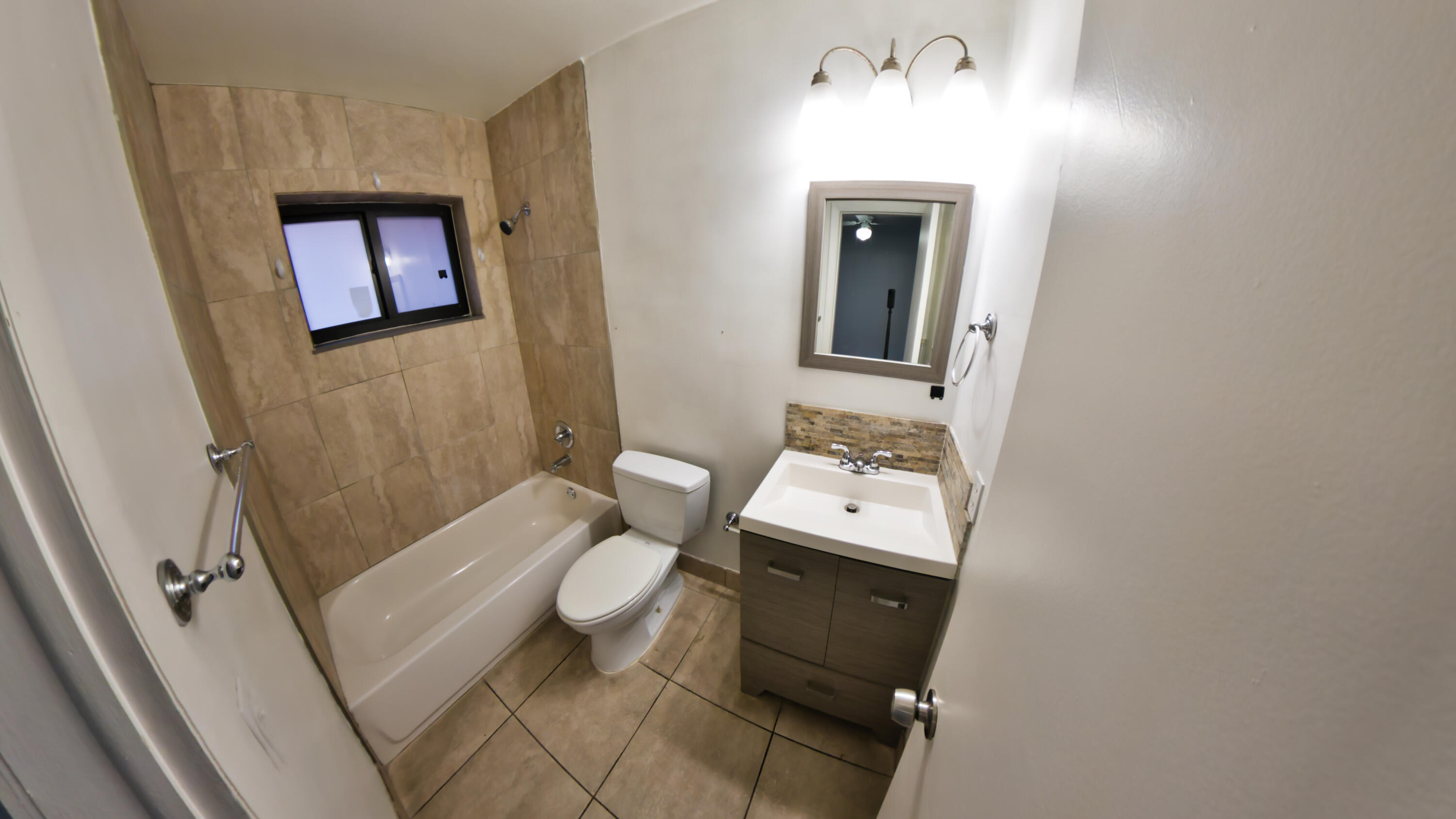 2620 Southwest 32nd Avenue Miami, FL 33133 - Photo 16 of 19 a bathroom with a toilet sink and mirror