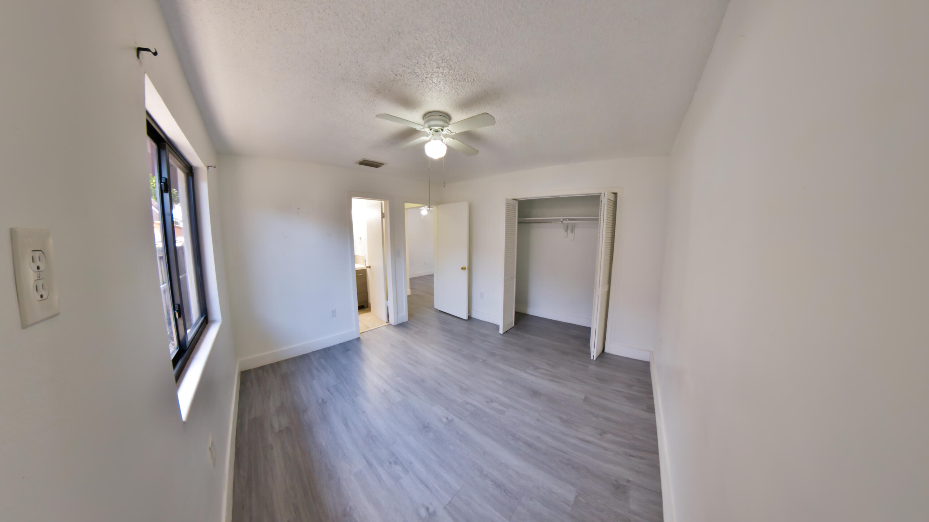 2620 Southwest 32nd Avenue Miami, FL 33133 - Photo 17 of 19 a view of a hallway with wooden floor and a ceiling fan