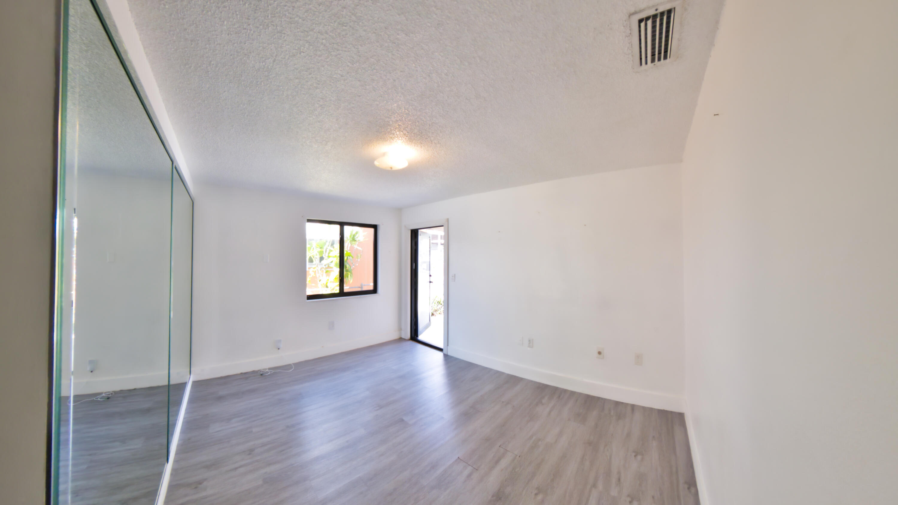 2620 Southwest 32nd Avenue Miami, FL 33133 - Photo 19 of 19 an empty room with wooden floor and windows
