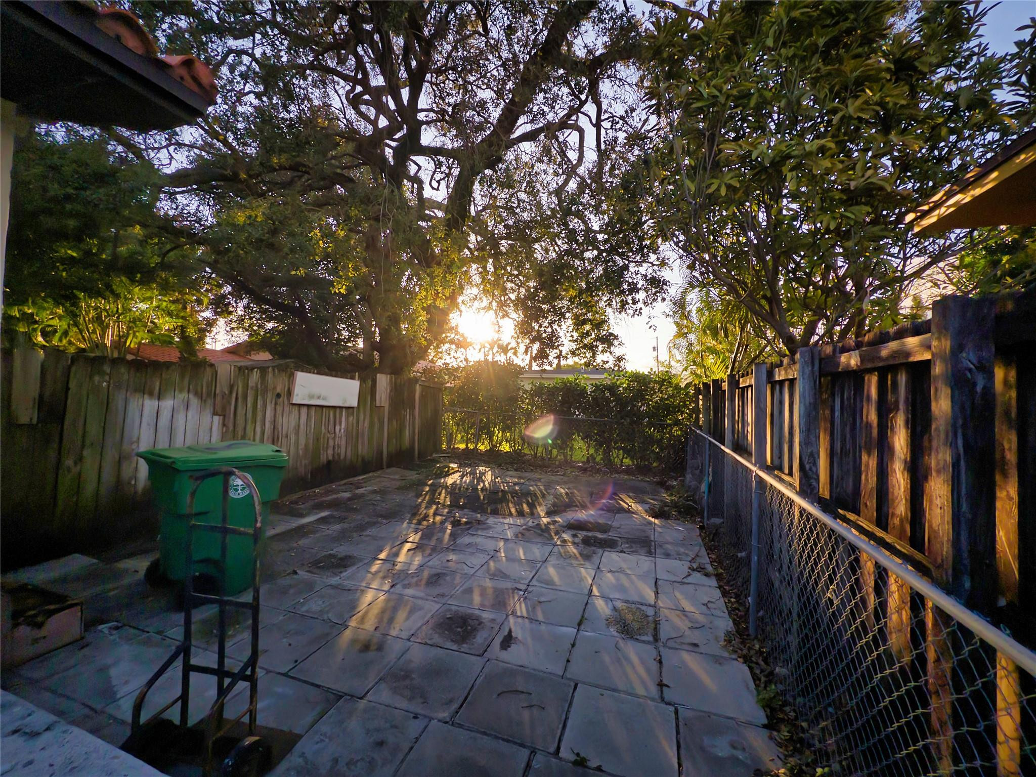 2620 Southwest 32nd Avenue Miami, FL 33133 - Photo 3 of 19 a view of a backyard with wooden fence and a large tree