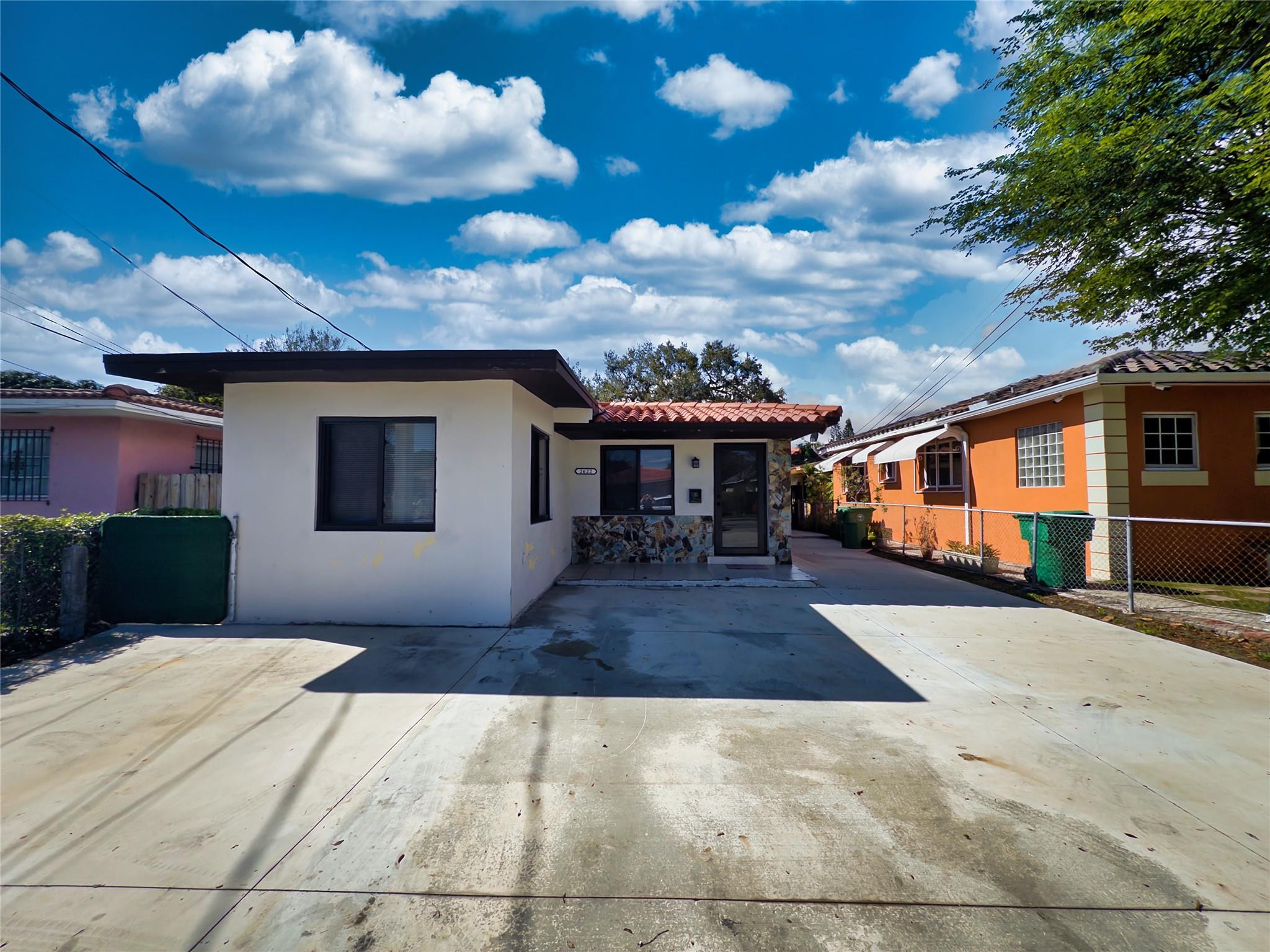 2620 Southwest 32nd Avenue Miami, FL 33133 - Photo 5 of 19 a front view of a house with a yard and garage