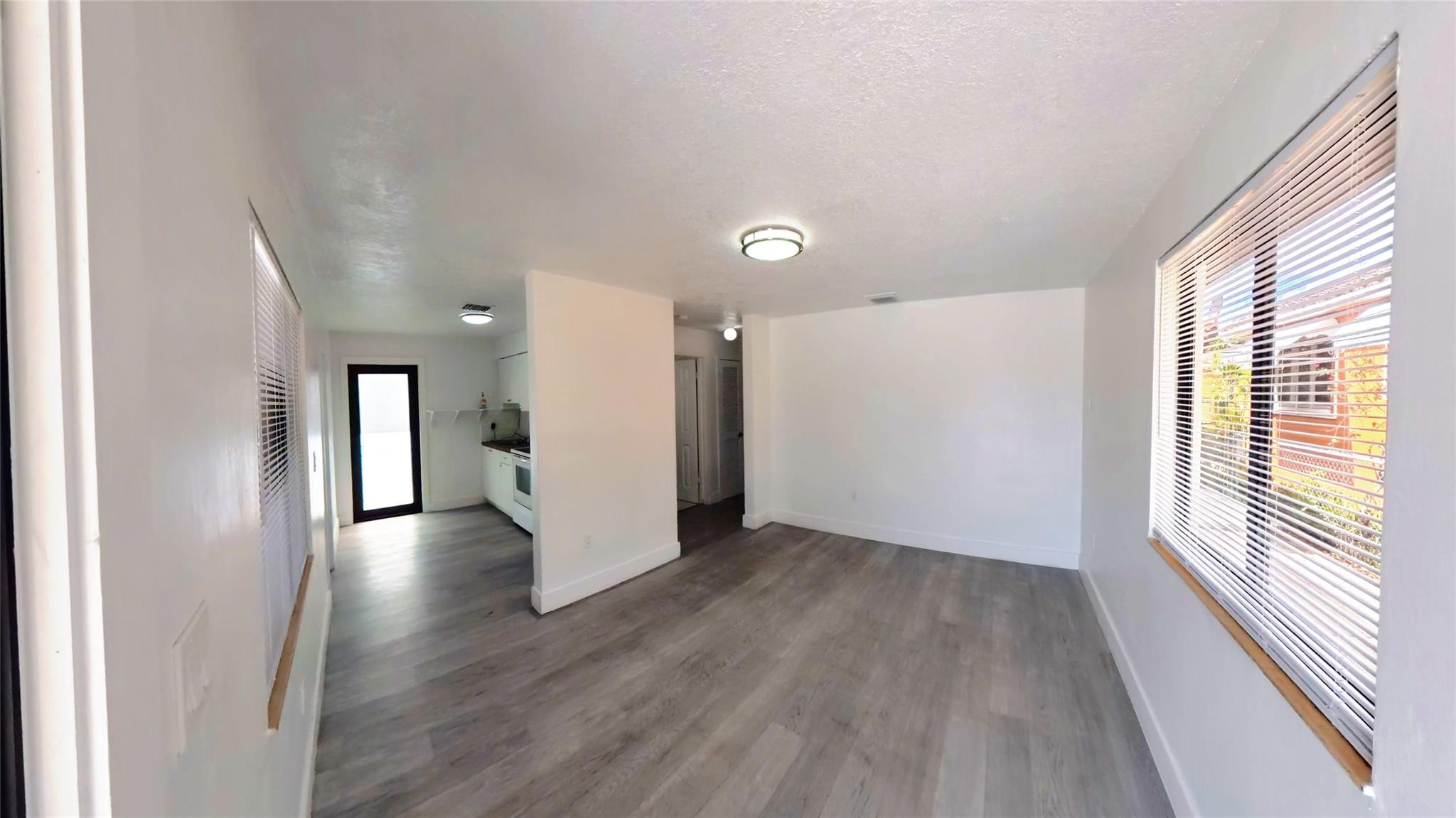 2620 Southwest 32nd Avenue Miami, FL 33133 - Photo 9 of 19 a view of a hallway with wooden floor and windows