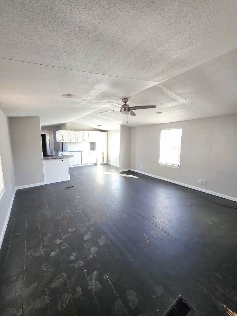 310 Paddock Street, Unit 5 Willis, TX 77378 - Photo 3 of 12 an empty room with wooden floor and windows