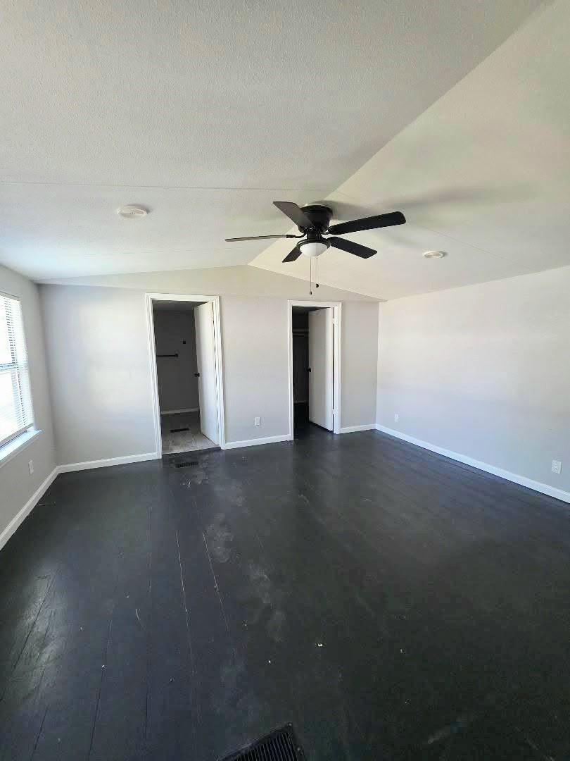 310 Paddock Street, Unit 5 Willis, TX 77378 - Photo 6 of 12 a view of empty room with wooden floor and fan