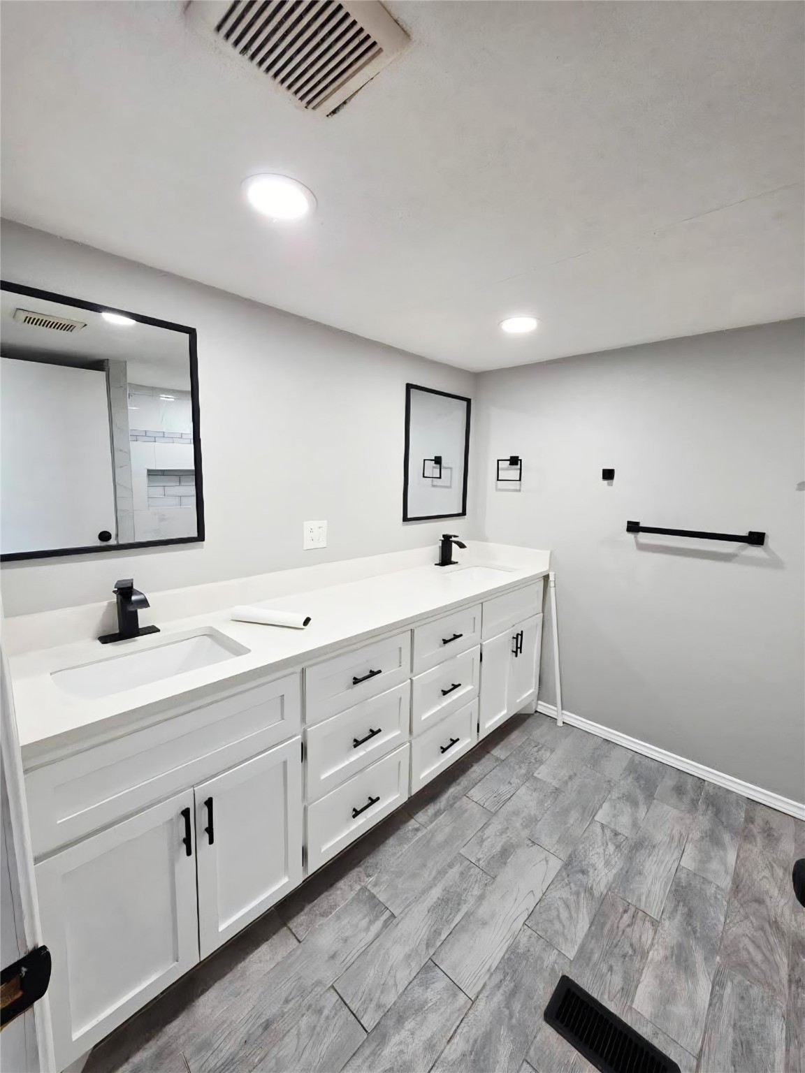 310 Paddock Street, Unit 5 Willis, TX 77378 - Photo 7 of 12 a spacious bathroom with a double vanity sink and mirror