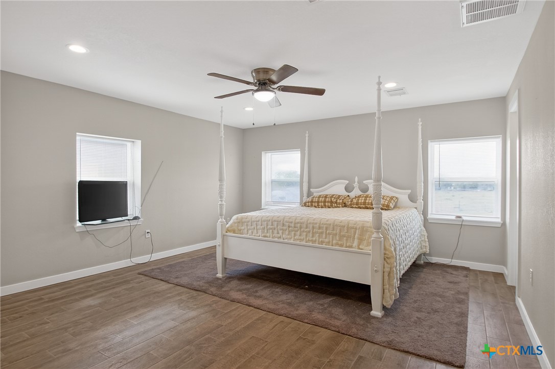 617 Bartlett Road Victoria, TX 77905 - Photo 15 of 30 a bedroom with a bed and a flat screen tv