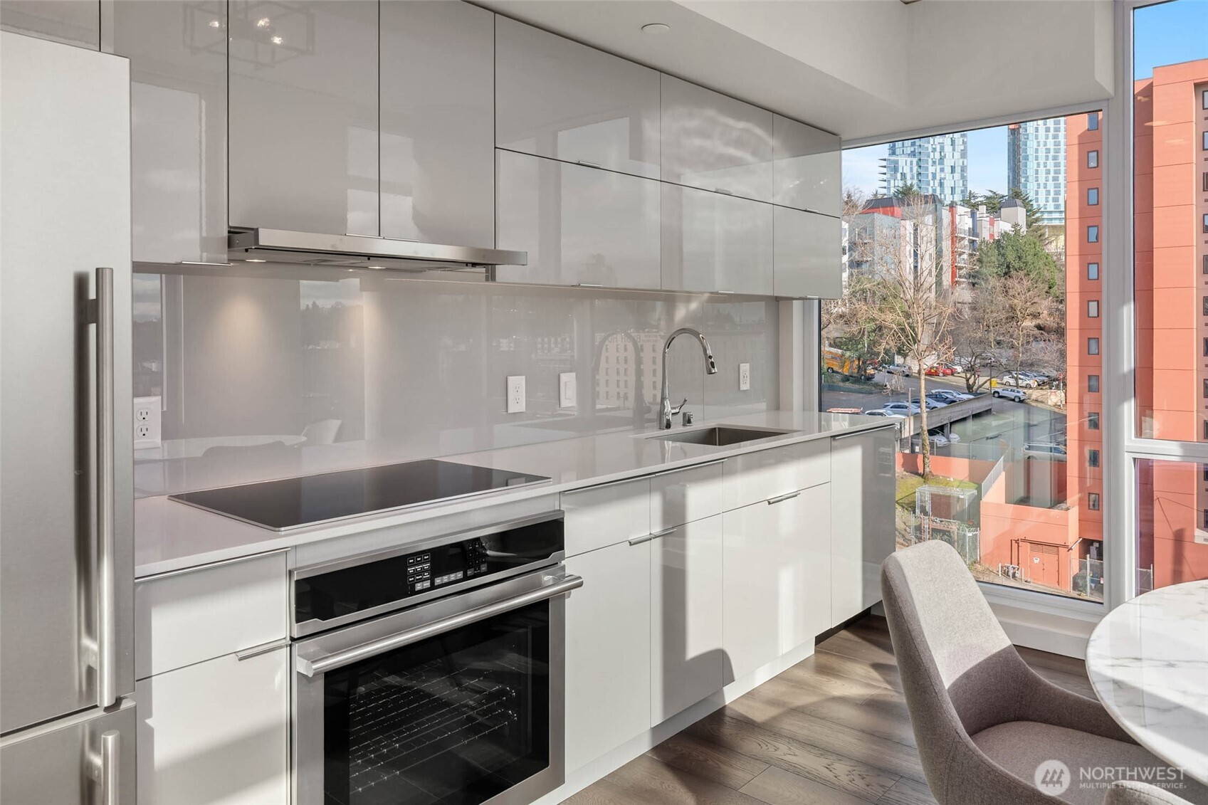 450 South Main Street, Unit 806 Seattle, WA 98104 - Photo 7 of 25 a kitchen with granite countertop a stove and a sink