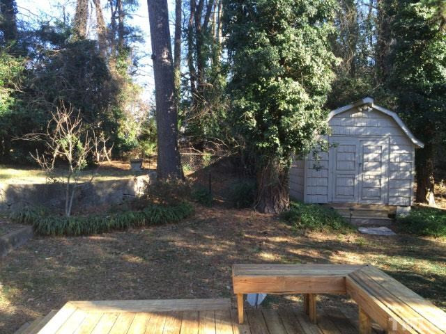 1216 Brookside Drive Raleigh, NC 27604 - Photo 7 of 24 The 14x10 ft wired workshop/studio/storage shed sits just beyond the back deck.