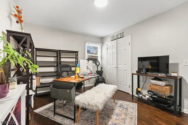 a bedroom with furniture and a flat screen tv